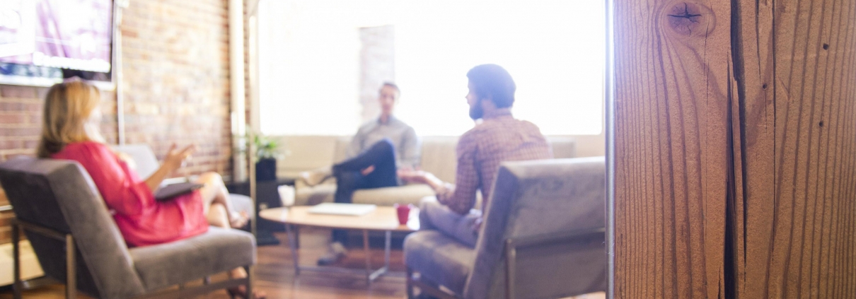 Group of people having a business meeting in a modern office with natural light