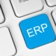 Computer keyboard with a blue ERP key representing enterprise resource planning software